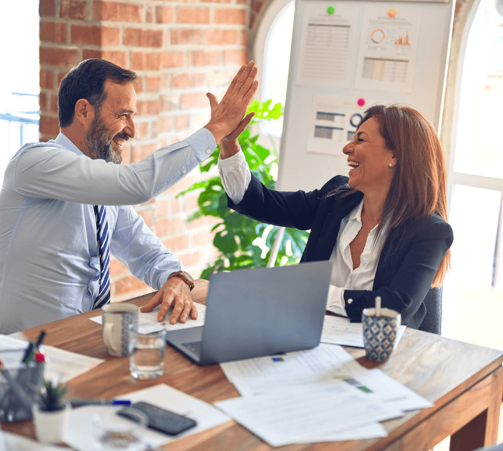 A woman and a man high-five each other